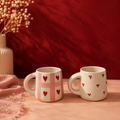 Ceramic mug duo — pink checkered heart mug and scattered heart mug, matching set
