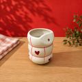 Handmade cream ceramic tumbler with red gingham checks and hearts, bubble texture
